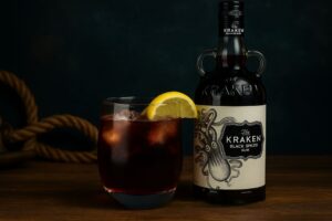 a image of a glass of rum and a kraken's rum bottle
